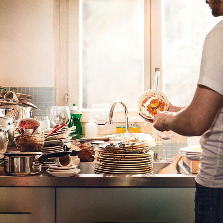 Dirty dishes stacked in the sink