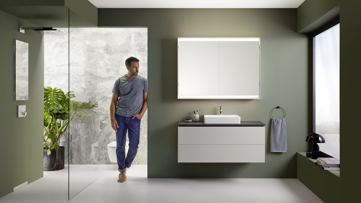 Man standing in a bathroom featuring the Geberit ONE bathroom series