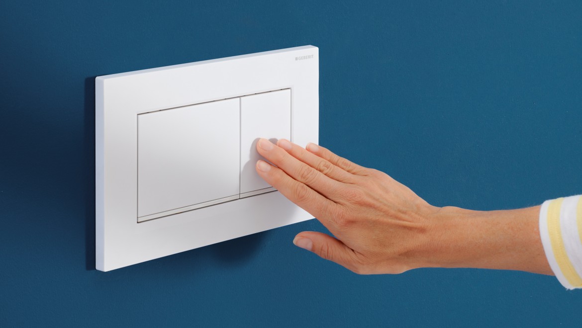 Person presses the small the small button on the white Sigma30 actuator plate Person presses the small the small button on the white Sigma30 actuator plate