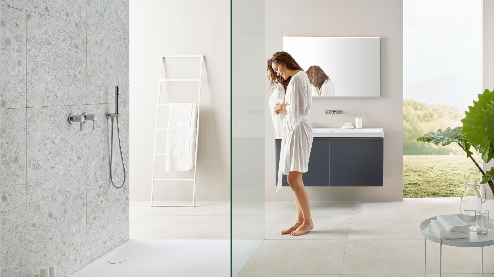 Woman standing in a bathroom with a walk-in shower Woman standing in a bathroom with a walk-in shower