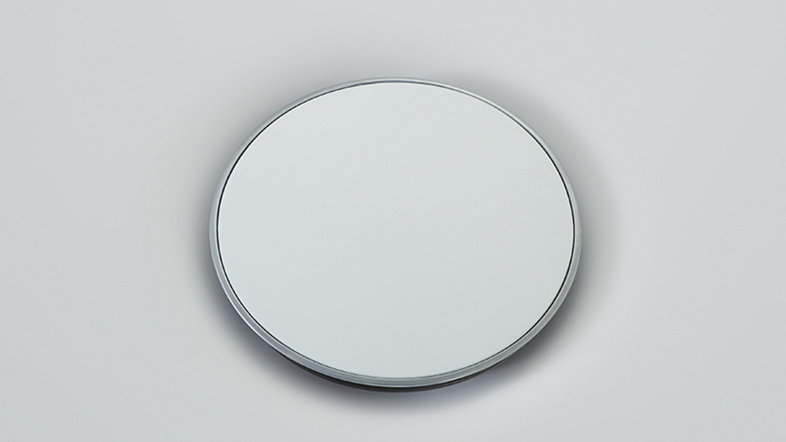 Geberit Olona drain cover sorrounded by a slim chrome ring