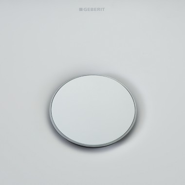 Geberit Olona drain cover sorrounded by a slim chrome ring