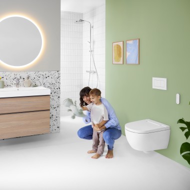 Woman and child in a colourful bathroom with Geberit Option mirror