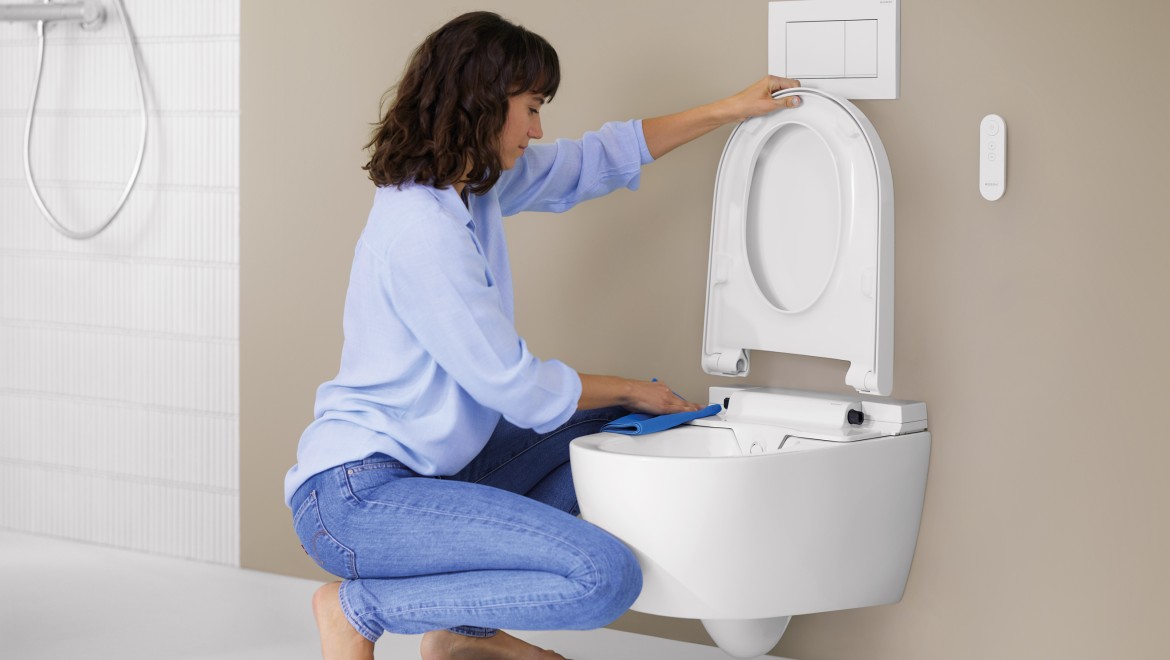 Woman cleans Geberit AquaClean Alba Woman cleans Geberit AquaClean Alba