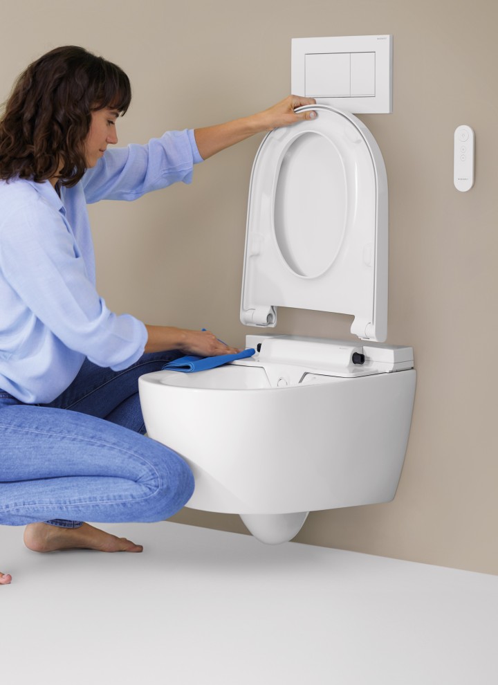 Woman cleans Geberit AquaClean Alba Woman cleans Geberit AquaClean Alba