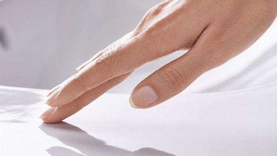 Hand brushing over a smooth ceramic surface with Geberit KeraTect