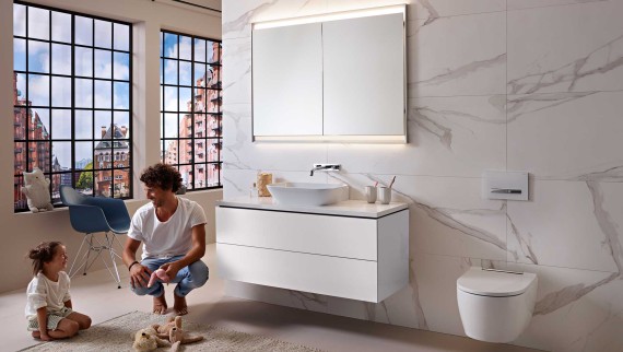 Man and child in a white bathroom from the Geberit ONE series