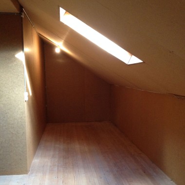 Small attic bathroom with a sloped ceiling prior to renovation