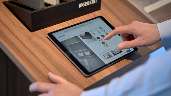 Man with tablet selects products in a configurator Man with tablet selects products in a configurator