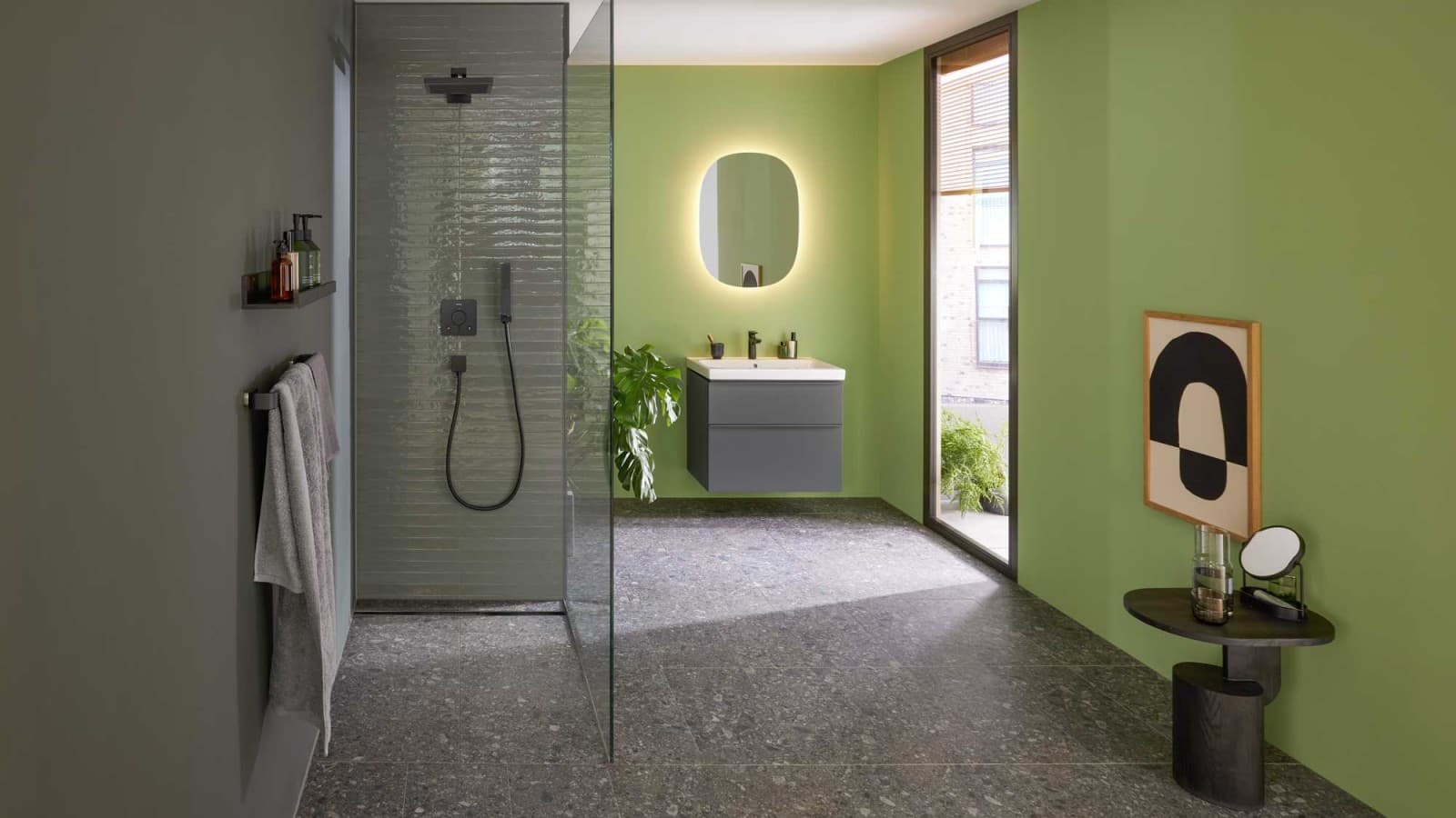 Green bathroom featuring Geberit iCon furniture and ceramics, a black Geberit CleanLine30 shower channel and an oval Geberit Option mirror. Green bathroom featuring Geberit iCon furniture and ceramics, a black Geberit CleanLine30 shower channel and an oval Geberit Option mirror.