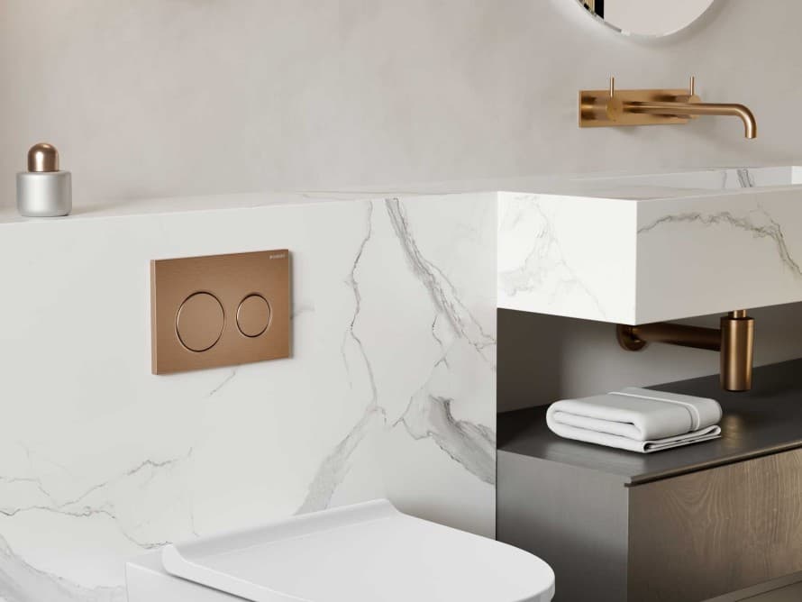Bathroom featuring a Geberit flush plate in red gold Bathroom featuring a Geberit flush plate in red gold